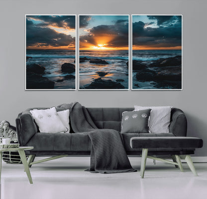 An awe-inspiring sunset over the ocean with rays of light piercing through dramatic clouds, creating a beautiful seascape with rocks in the foreground.