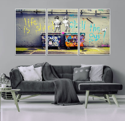 Graffiti-style canvas art with bold text and two naked figures over urban dumpsters, ideal for edgy or street-style decor.