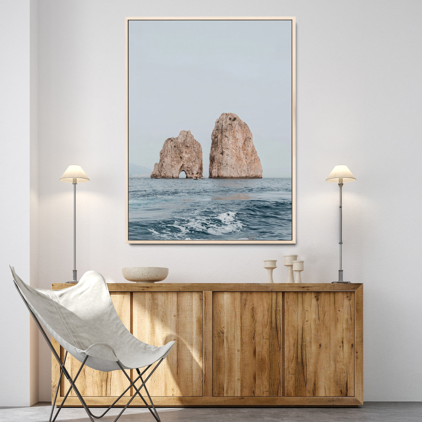 Serene photograph of the Faraglioni rocks in Capri with calm blue waters, perfect for Mediterranean coastal or minimalist travel-themed decor.