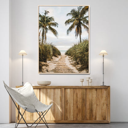 Canvas wall art of a tropical beach path with palm trees and dune grass, ideal for coastal entryways or tropical-inspired home decor.