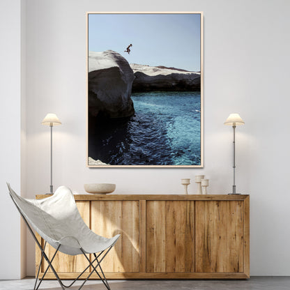 Canvas of a cliff diver above turquoise waters and rocky coastline under clear sky, ideal for adventurous minimalist or coastal home decor.