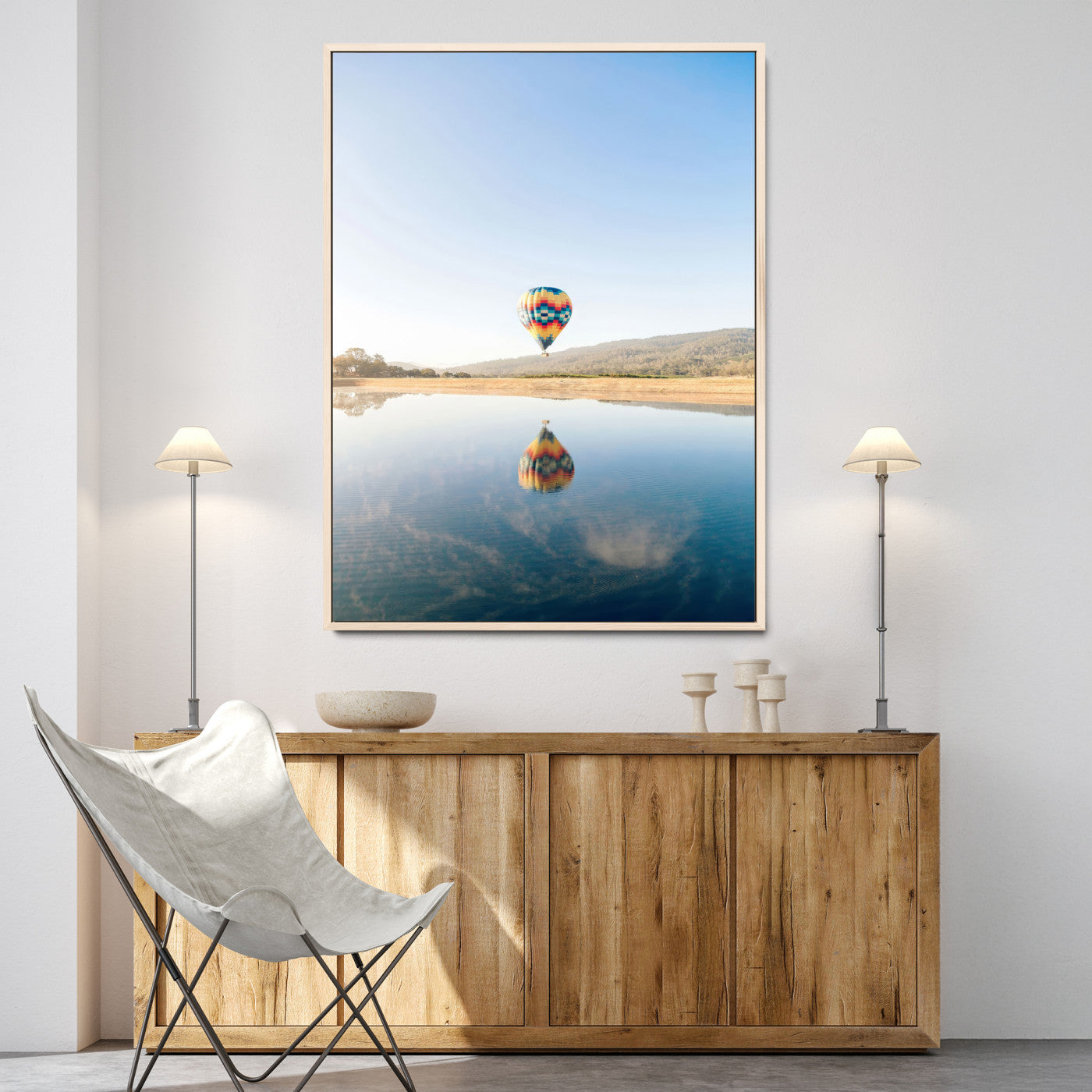 Canvas of a hot air balloon floating above a calm lake with soft reflections and vibrant sky, ideal for modern minimalist or adventure-themed home decor.