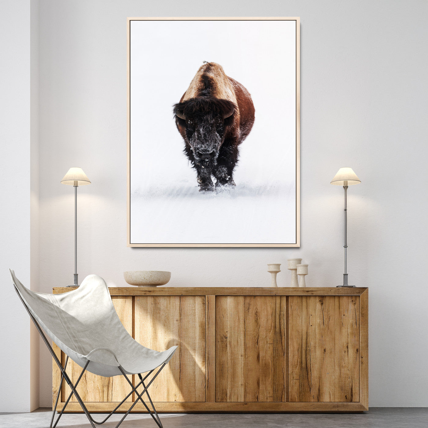Front view of a strong bison walking in deep snow, isolated white background, perfect for rustic or lodge-style home decor.