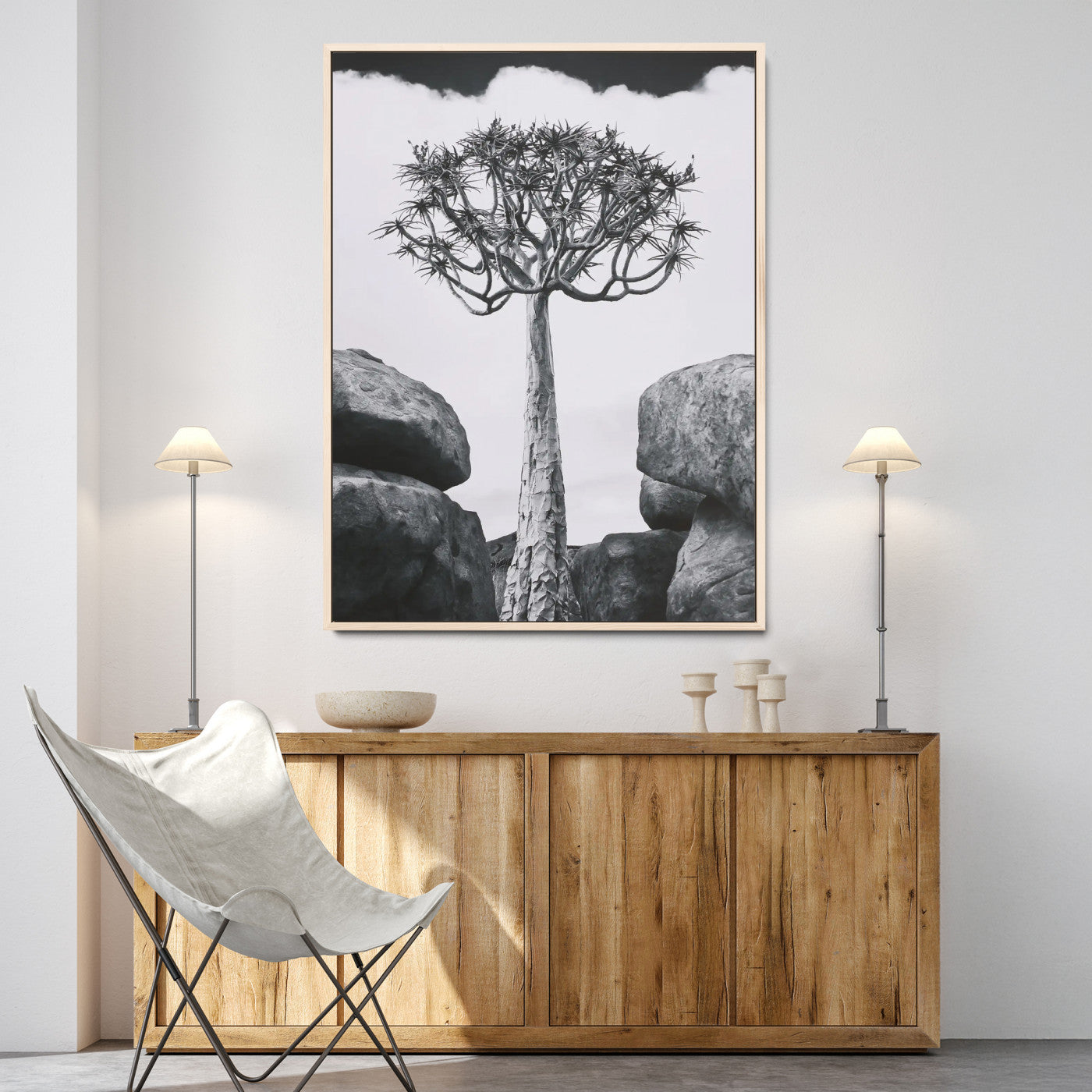 Tall desert tree in black and white, standing between large rocks, perfect for bold and minimalist nature-themed interior spaces.