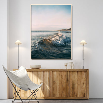Close-up of ocean waves rolling gently toward the shore at sunset, creating a peaceful and minimalist coastal scene.