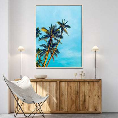 "Tall palm trees with golden sunlight against a vibrant blue sky, creating a tropical, relaxing atmosphere for coastal and beach-themed decor.