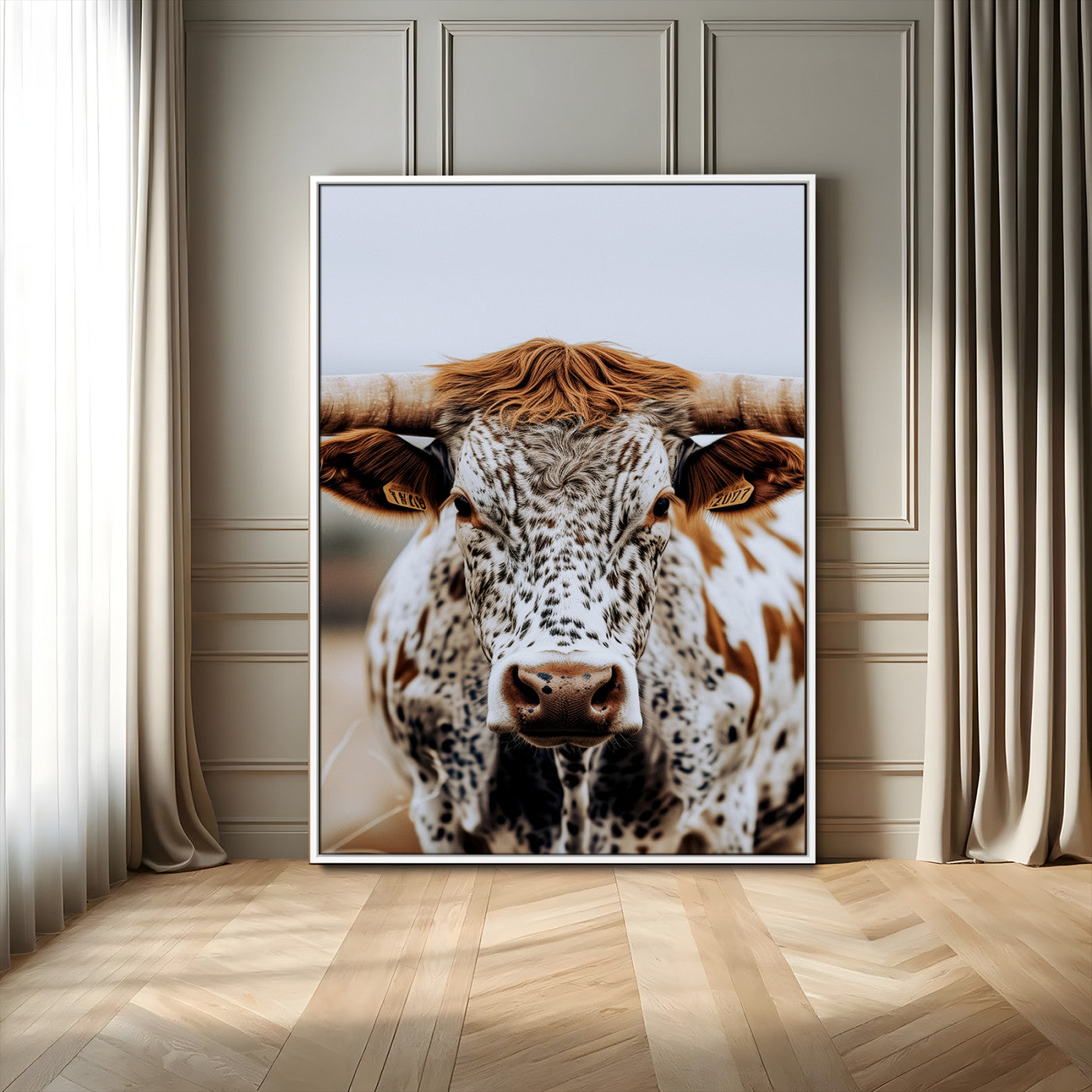 Close-up of a speckled Texas longhorn with wide horns and a bold gaze, perfect for rustic or country-style decor in warm tones.
