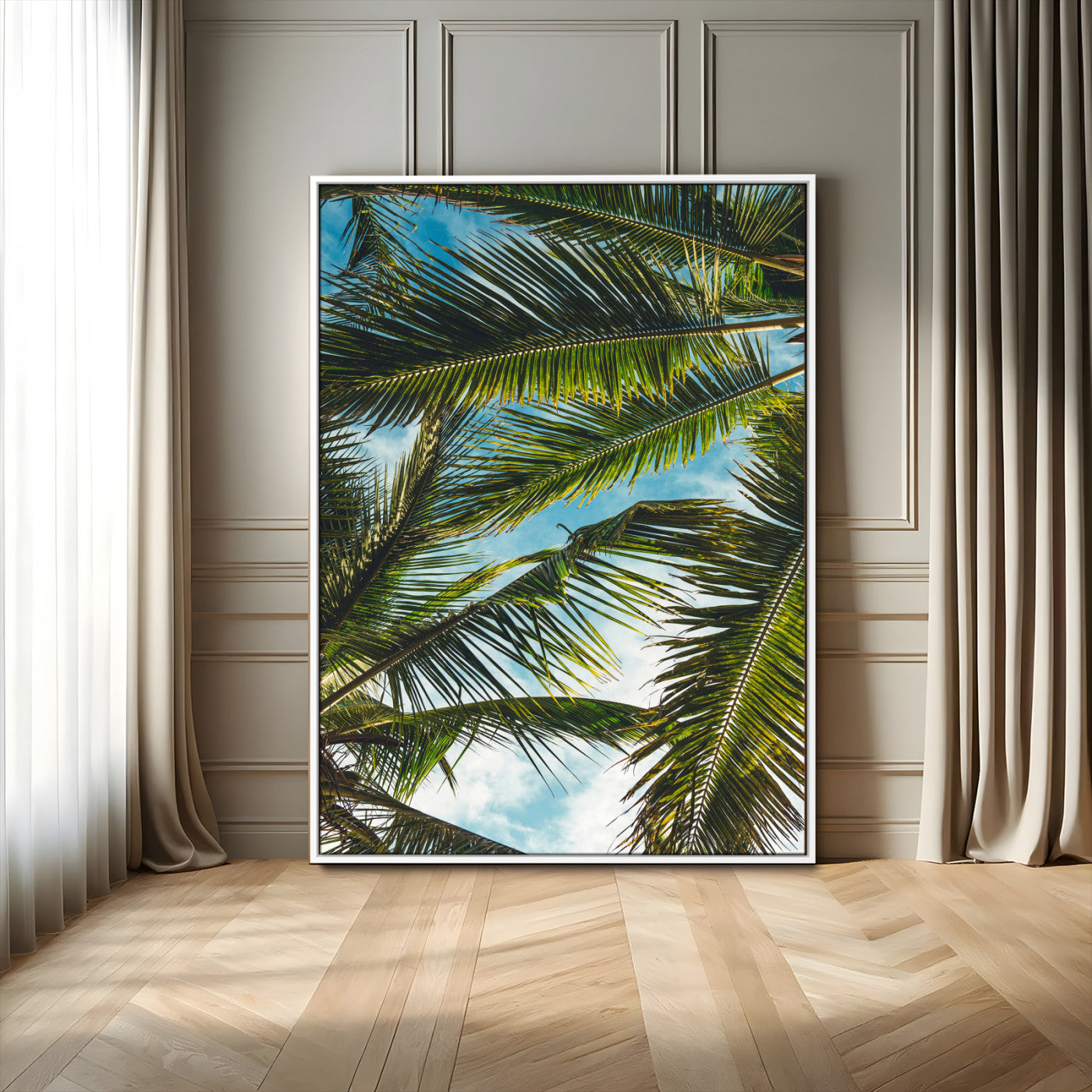 Looking up at lush green palm leaves against a bright blue sky, creating a tropical and relaxing coastal aesthetic.