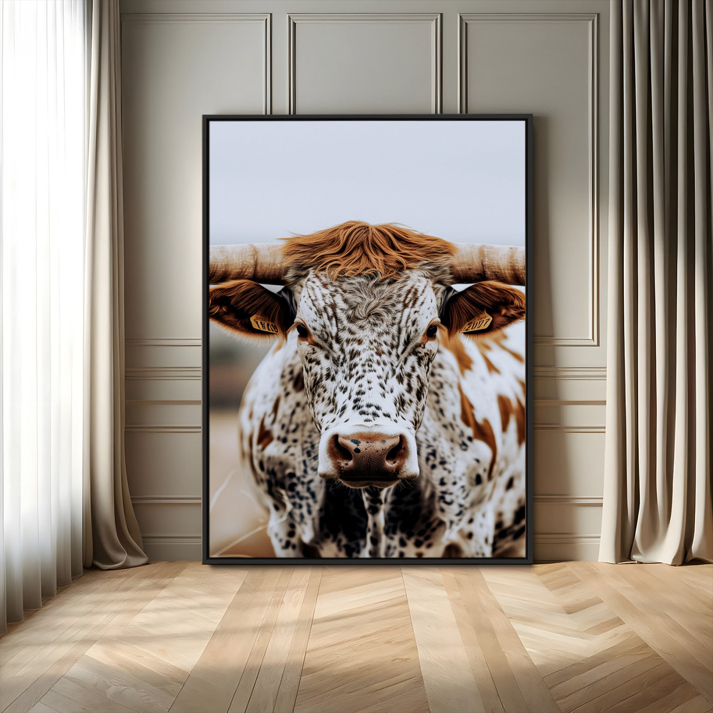 Close-up of a speckled Texas longhorn with wide horns and a bold gaze, perfect for rustic or country-style decor in warm tones.