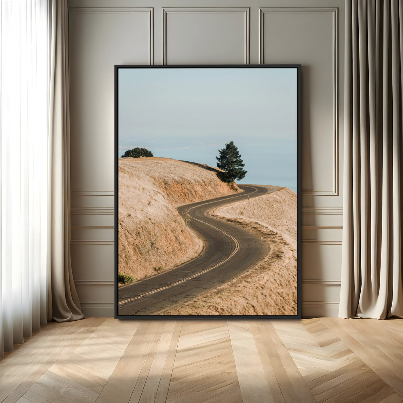Earth-toned photograph of a winding road through golden hills, ideal for neutral or rustic-themed decor with a calming travel vibe.