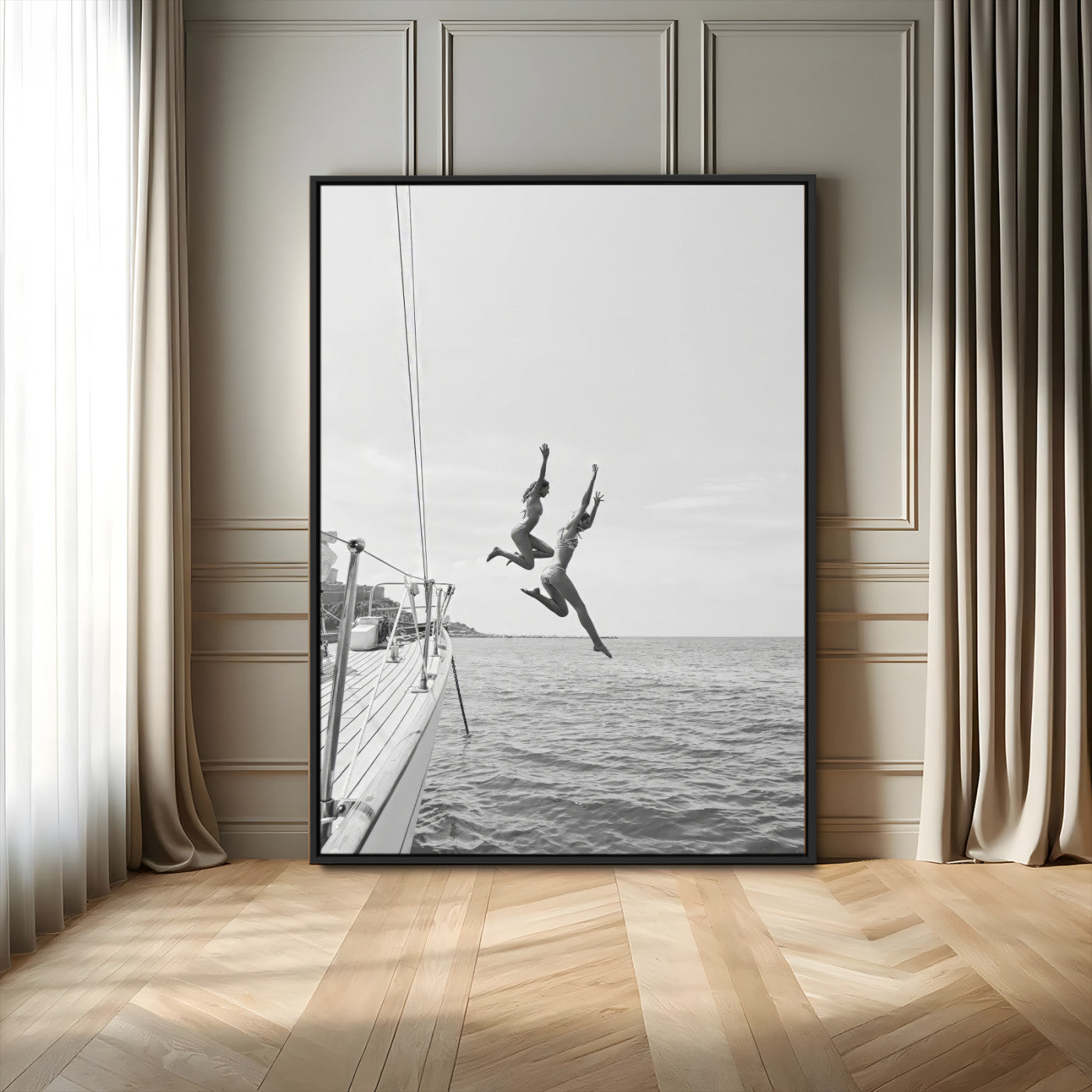 Black and white canvas wall art of two women joyfully jumping off a yacht into the sea, ideal for minimalist coastal or nautical-themed spaces.