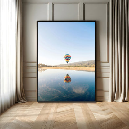 Canvas of a hot air balloon floating above a calm lake with soft reflections and vibrant sky, ideal for modern minimalist or adventure-themed home decor.