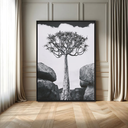 Tall desert tree in black and white, standing between large rocks, perfect for bold and minimalist nature-themed interior spaces.