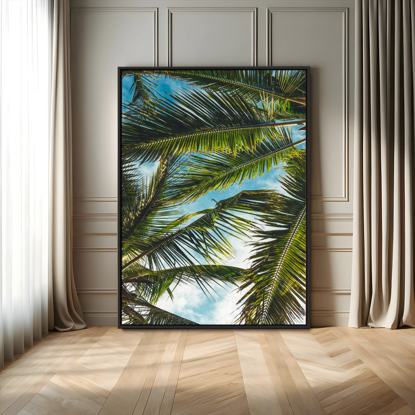 Looking up at lush green palm leaves against a bright blue sky, creating a tropical and relaxing coastal aesthetic.