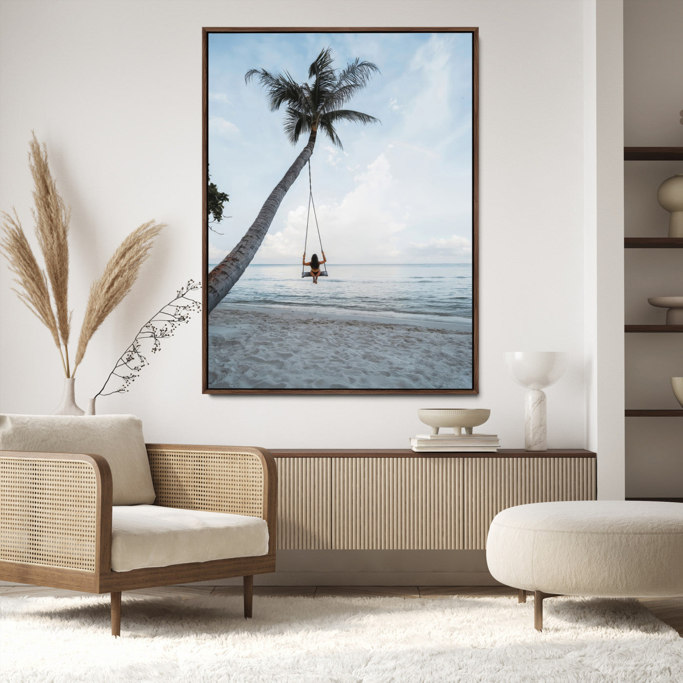 Wall art of a girl on a swing hanging from a palm tree over calm ocean waters, perfect for tropical or minimalist coastal decor.