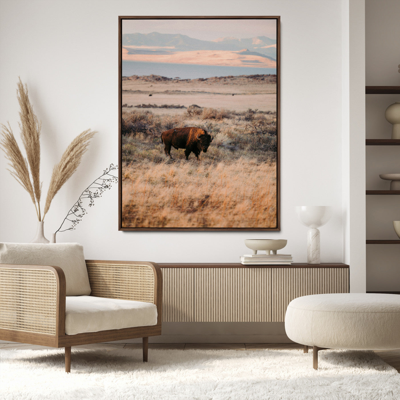 A solitary bison standing in golden prairie grass with distant mountains and soft sunset light, ideal for rustic, lodge, and western decor.