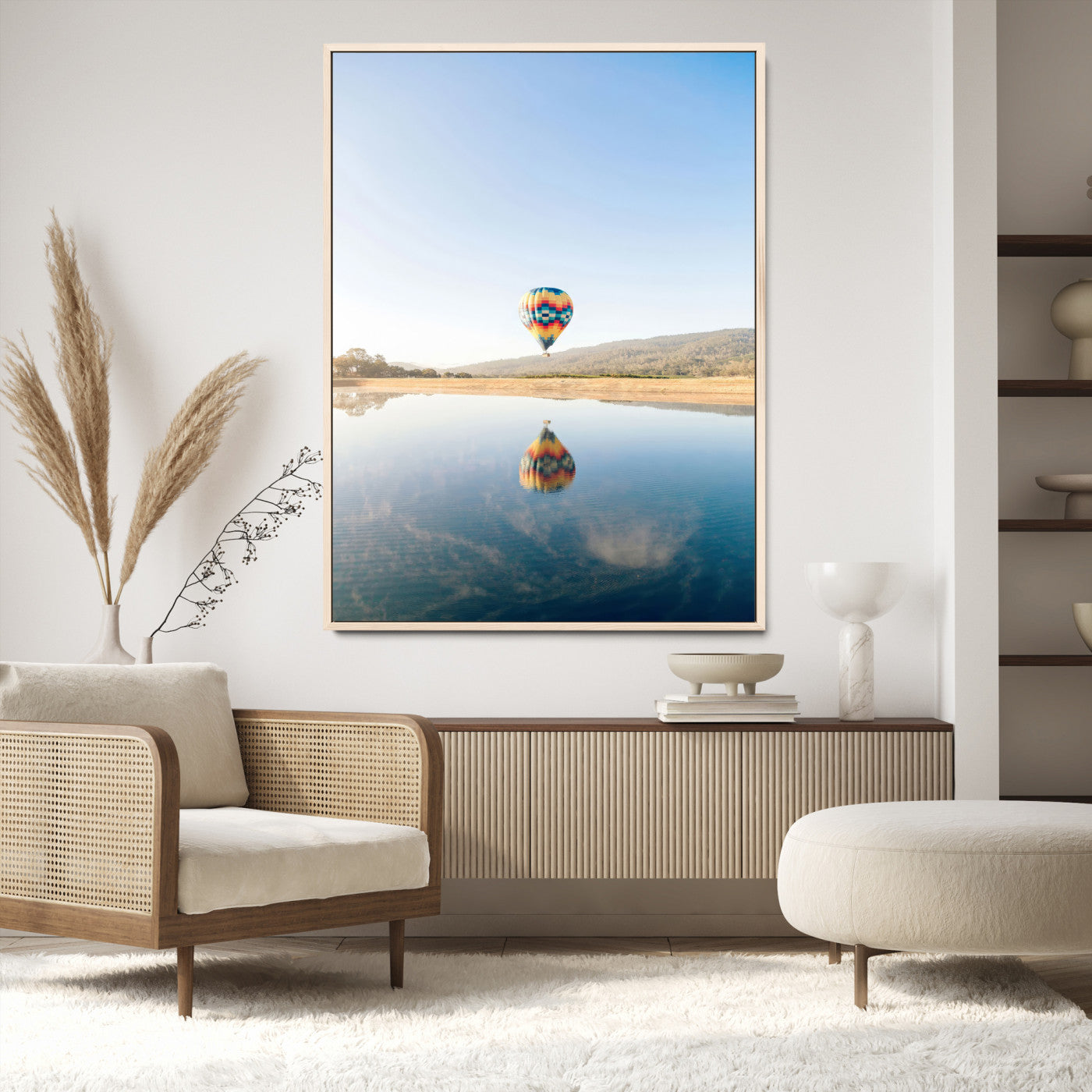 Canvas of a hot air balloon floating above a calm lake with soft reflections and vibrant sky, ideal for modern minimalist or adventure-themed home decor.