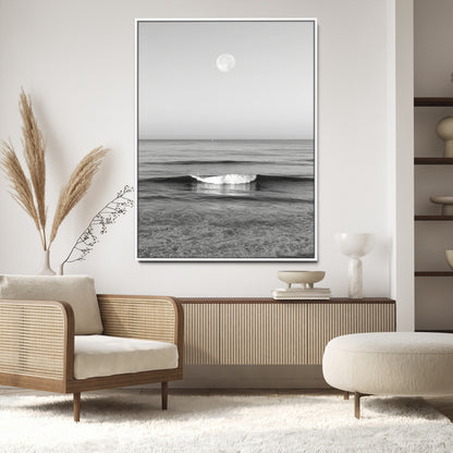 Black and white wall art of a calm ocean wave beneath a full moon, ideal for minimalist or monochrome coastal decor.