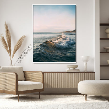 Close-up of ocean waves rolling gently toward the shore at sunset, creating a peaceful and minimalist coastal scene.