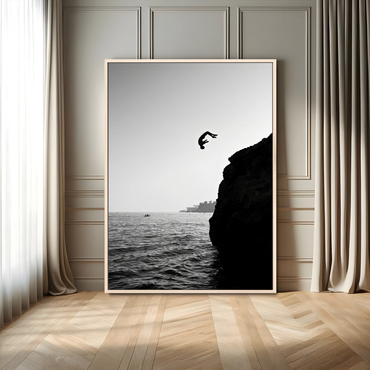 Silhouette of a person mid-air during a cliff jump over the ocean, captured in black and white for minimalist adventure decor.