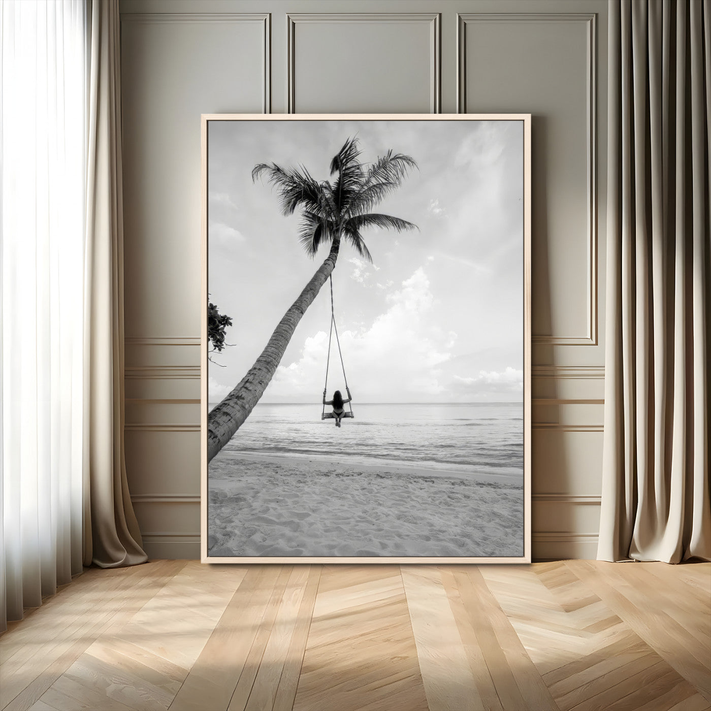 Monochrome photo of a woman swinging from a palm tree on a serene beach, ideal for minimalist or tropical coastal decor.