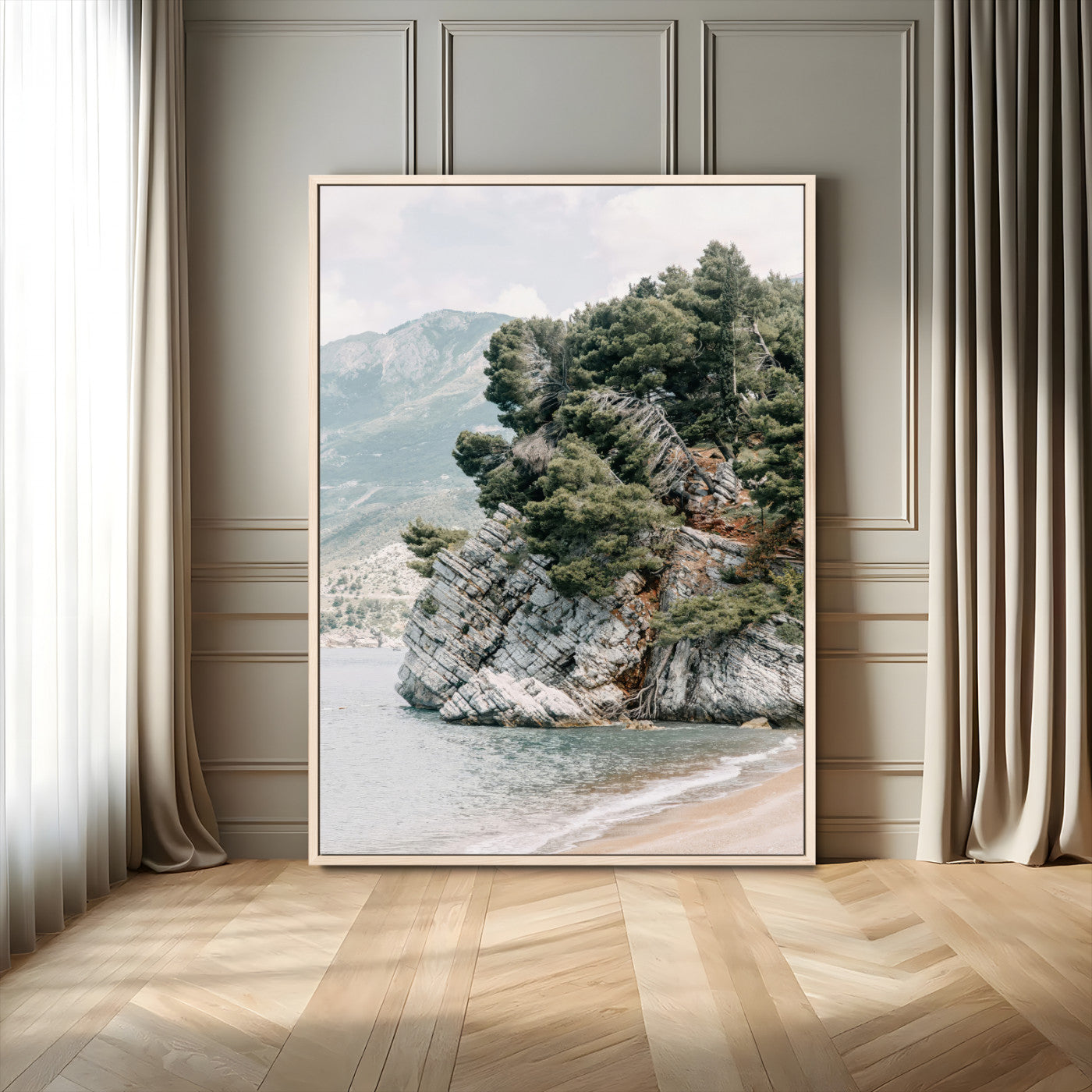 Framed photo of a rocky coastal cliff with dense greenery and calm shoreline, ideal for rustic coastal or earthy-toned home decor.