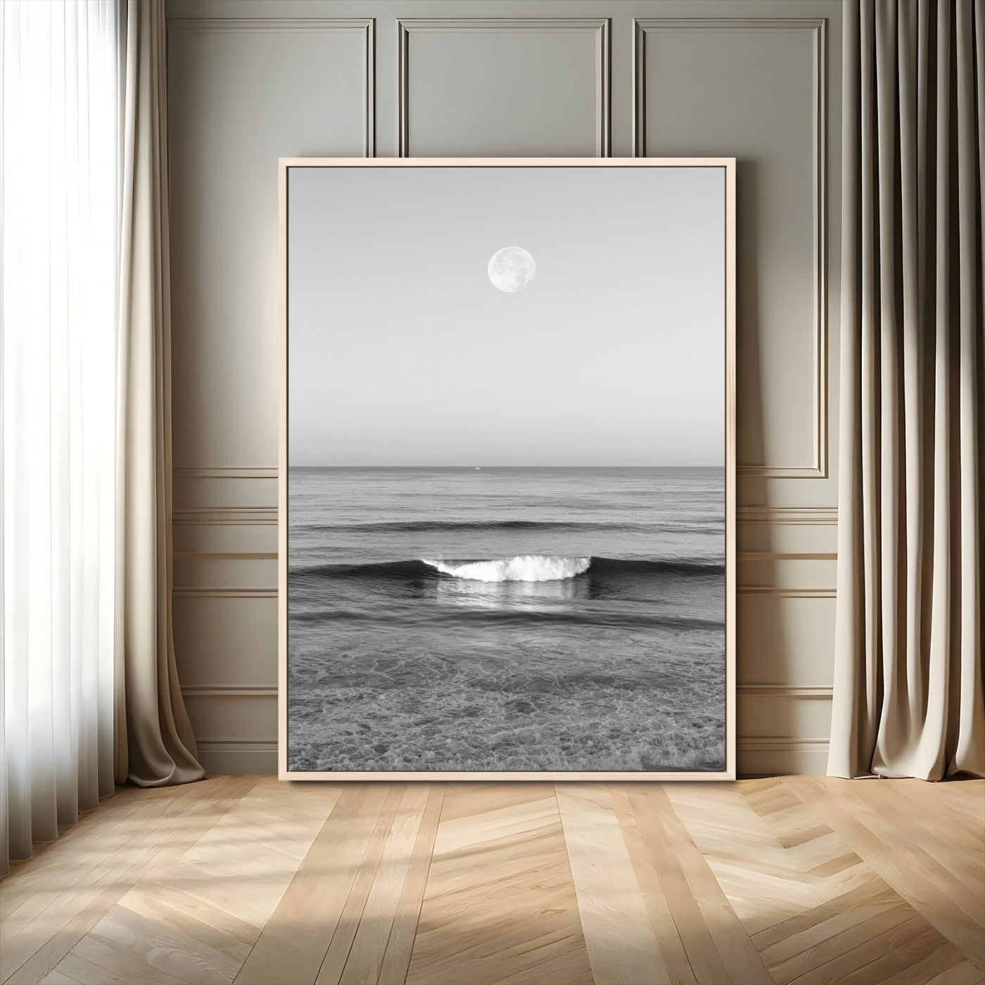 Black and white wall art of a calm ocean wave beneath a full moon, ideal for minimalist or monochrome coastal decor.
