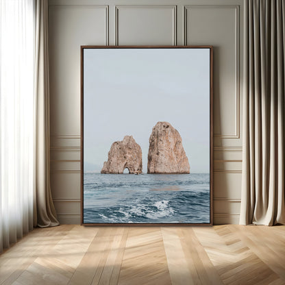 Serene photograph of the Faraglioni rocks in Capri with calm blue waters, perfect for Mediterranean coastal or minimalist travel-themed decor.