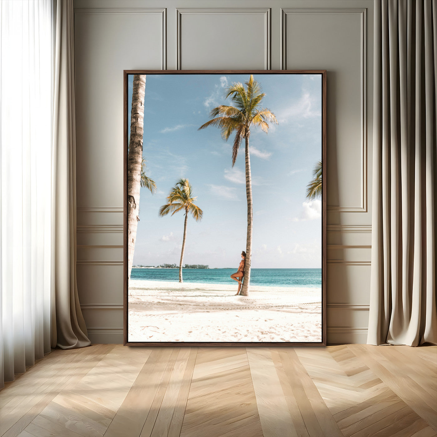 Person leaning on a palm tree at a tropical beach with white sand and turquoise water, perfect for coastal or beach-themed home decor.