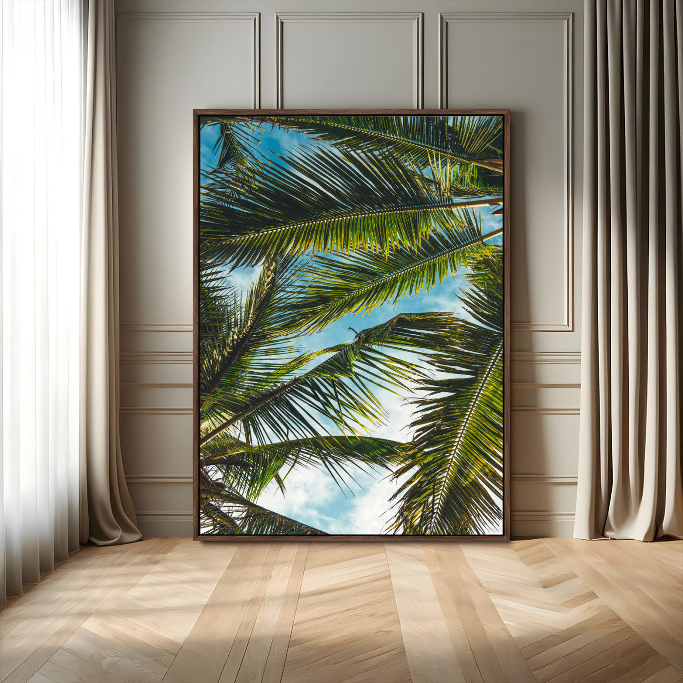 Looking up at lush green palm leaves against a bright blue sky, creating a tropical and relaxing coastal aesthetic.