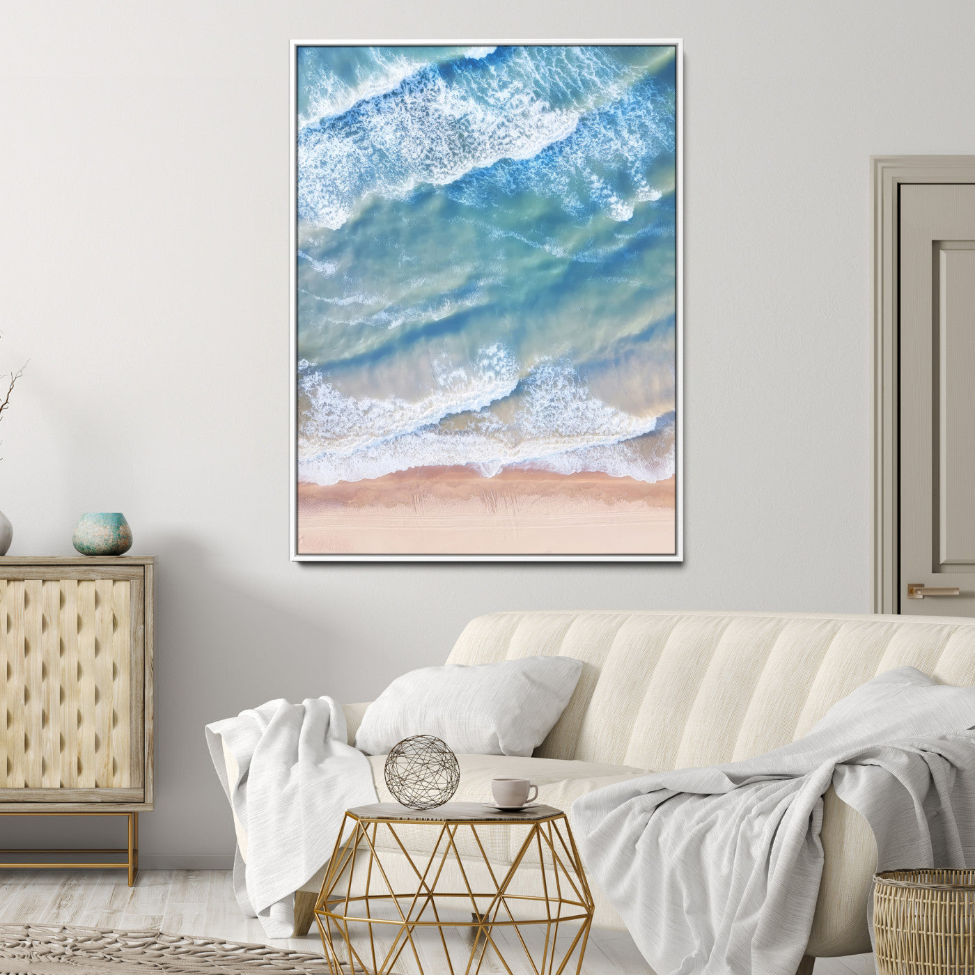 Aerial photo of soft blue waves meeting sandy shore, perfect for modern coastal or beach-themed decor with a light and tranquil aesthetic.
