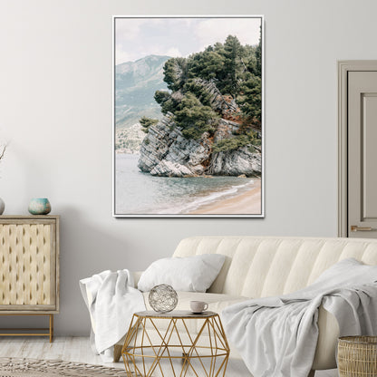 Framed photo of a rocky coastal cliff with dense greenery and calm shoreline, ideal for rustic coastal or earthy-toned home decor.