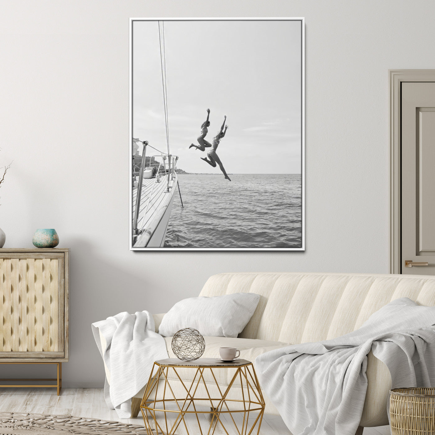 Black and white canvas wall art of two women joyfully jumping off a yacht into the sea, ideal for minimalist coastal or nautical-themed spaces.