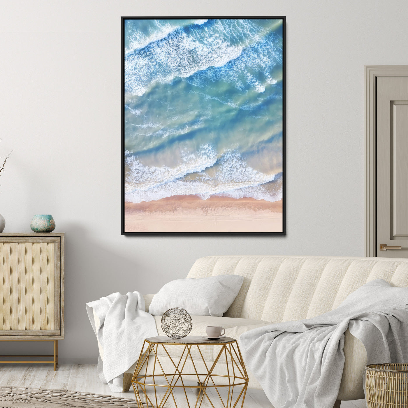 Aerial photo of soft blue waves meeting sandy shore, perfect for modern coastal or beach-themed decor with a light and tranquil aesthetic.