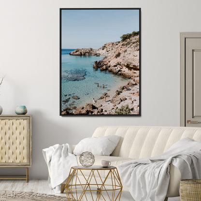 A vibrant coastal photo of a rocky Mediterranean cove with turquoise waters and beachgoers, ideal for boho coastal or summer-inspired interiors.