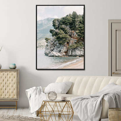 Framed photo of a rocky coastal cliff with dense greenery and calm shoreline, ideal for rustic coastal or earthy-toned home decor.