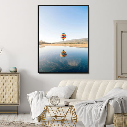 Canvas of a hot air balloon floating above a calm lake with soft reflections and vibrant sky, ideal for modern minimalist or adventure-themed home decor.