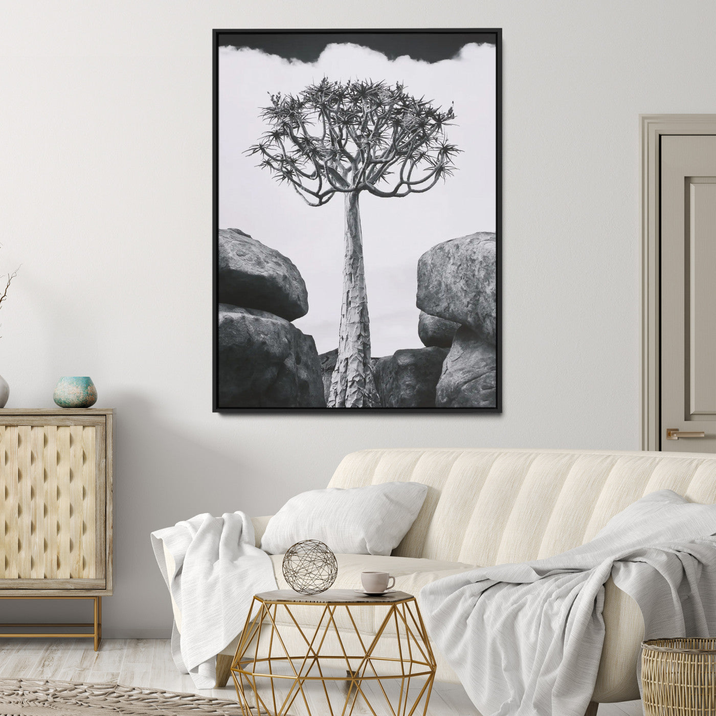 Tall desert tree in black and white, standing between large rocks, perfect for bold and minimalist nature-themed interior spaces.