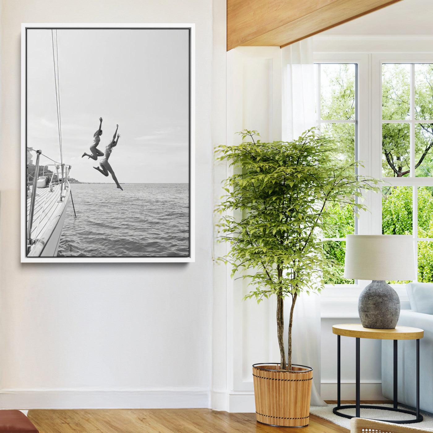 Black and white canvas wall art of two women joyfully jumping off a yacht into the sea, ideal for minimalist coastal or nautical-themed spaces.