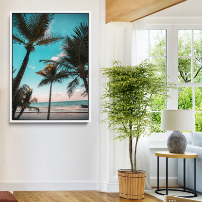 Tall palm trees swaying over a tropical beach with turquoise ocean waves and a soft sunset glow, creating a relaxing coastal vibe.