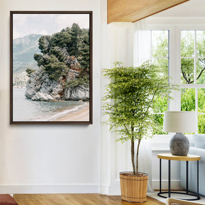 Framed photo of a rocky coastal cliff with dense greenery and calm shoreline, ideal for rustic coastal or earthy-toned home decor.