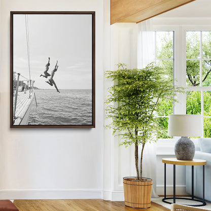 Black and white canvas wall art of two women joyfully jumping off a yacht into the sea, ideal for minimalist coastal or nautical-themed spaces.