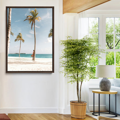Person leaning on a palm tree at a tropical beach with white sand and turquoise water, perfect for coastal or beach-themed home decor.
