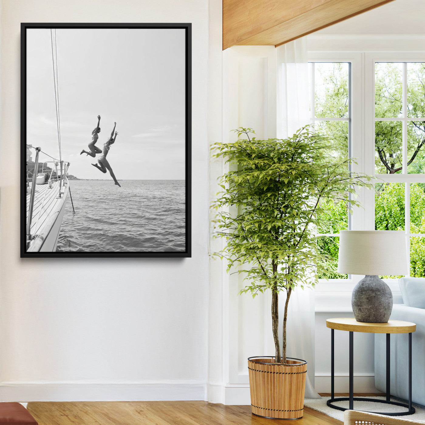 Black and white canvas wall art of two women joyfully jumping off a yacht into the sea, ideal for minimalist coastal or nautical-themed spaces.