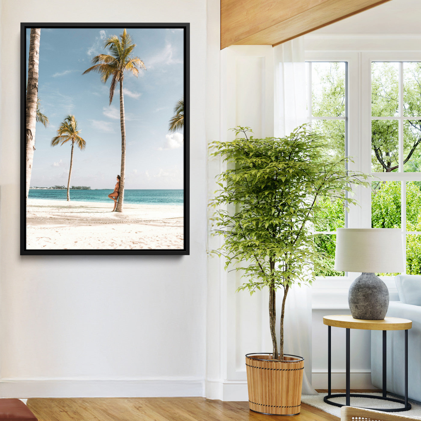Person leaning on a palm tree at a tropical beach with white sand and turquoise water, perfect for coastal or beach-themed home decor.