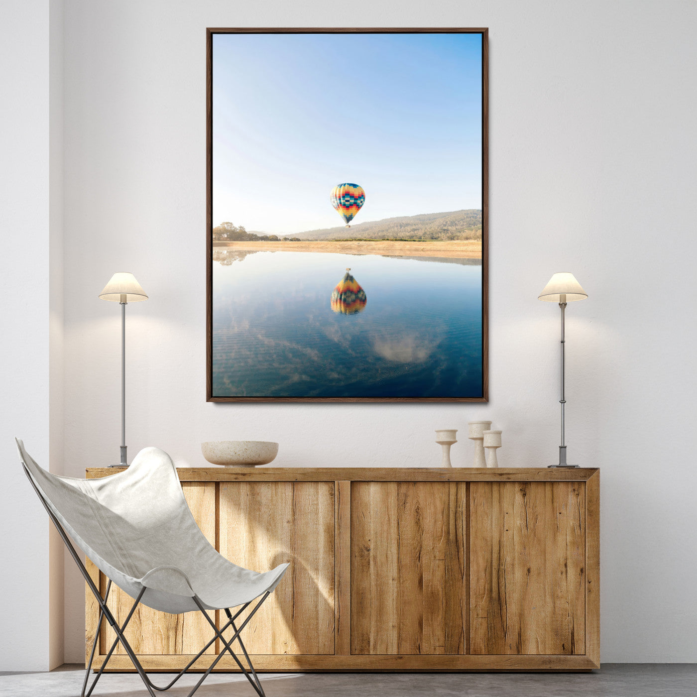 Canvas of a hot air balloon floating above a calm lake with soft reflections and vibrant sky, ideal for modern minimalist or adventure-themed home decor.