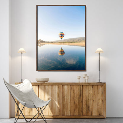 Canvas of a hot air balloon floating above a calm lake with soft reflections and vibrant sky, ideal for modern minimalist or adventure-themed home decor.