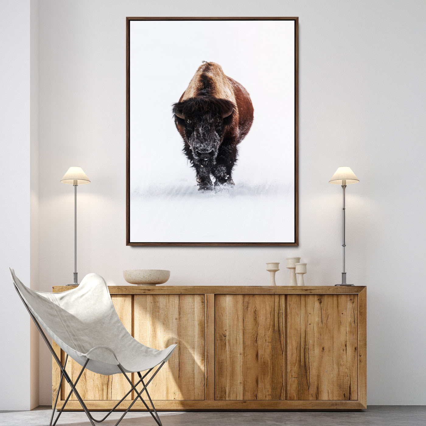 Front view of a strong bison walking in deep snow, isolated white background, perfect for rustic or lodge-style home decor.