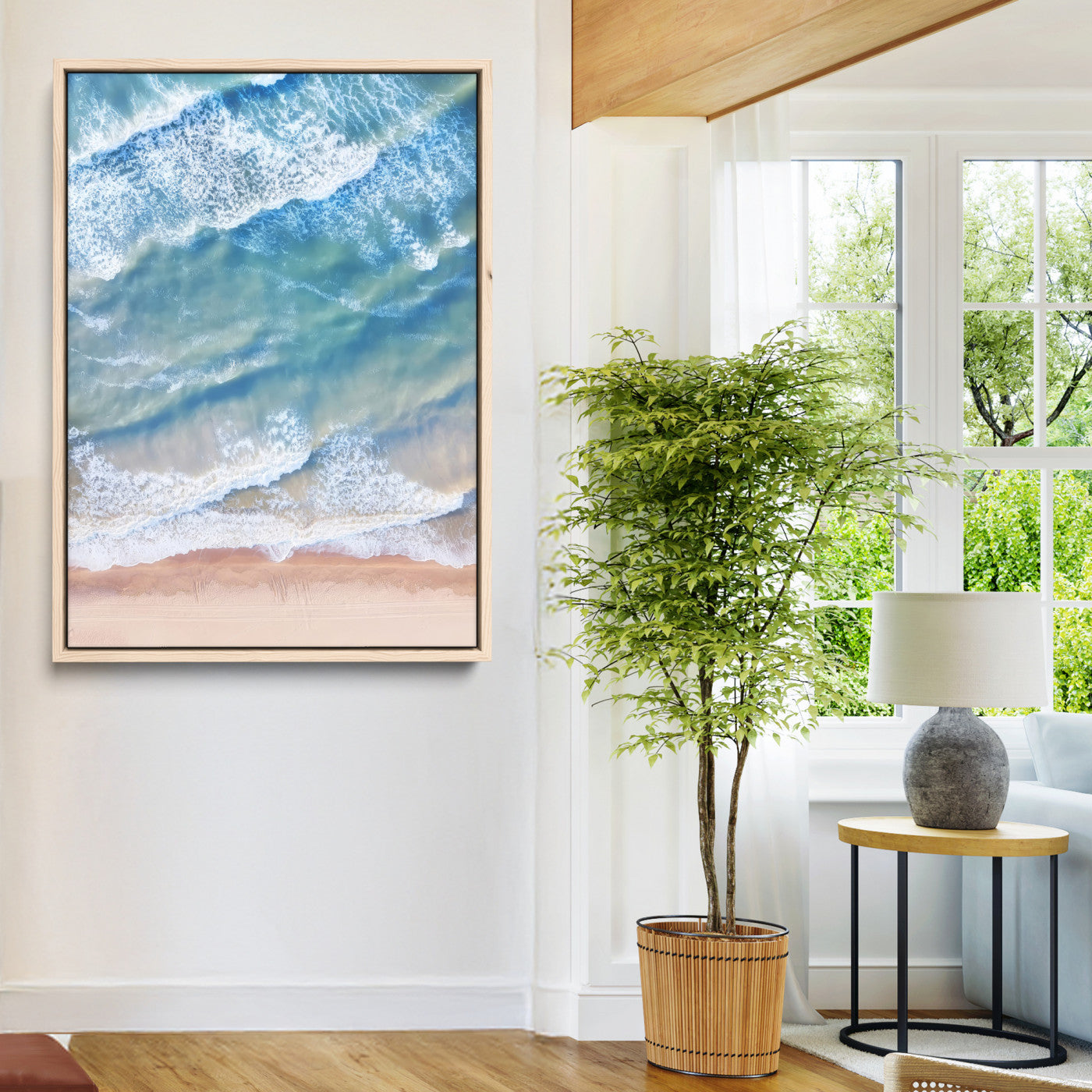 Aerial photo of soft blue waves meeting sandy shore, perfect for modern coastal or beach-themed decor with a light and tranquil aesthetic.