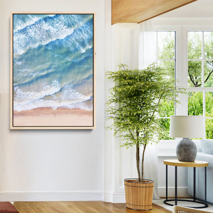 Aerial photo of soft blue waves meeting sandy shore, perfect for modern coastal or beach-themed decor with a light and tranquil aesthetic.